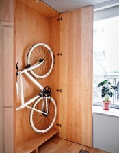 a simple plywood storage unit will let you store your bike and all the stuff related to it inside and hide it from everyone if your interior can’t welcome it