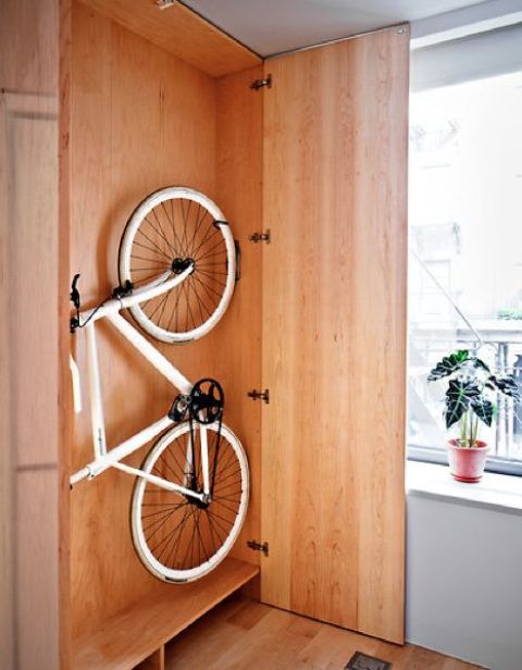 a simple plywood storage unit will let you store your bike and all the stuff related to it inside and hide it from everyone if your interior can't welcome it