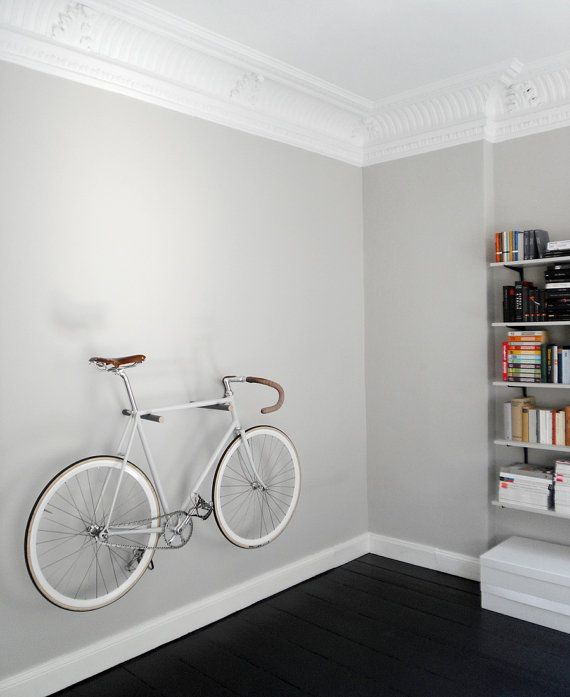 a couple of hooks attached to the wall will let your bike look ethereal and will add interest and dynamics to the interior at the same time