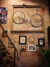an oversized frame on the wall and a couple of holders inside will make your bike a real artwork when the bike season isn’t on