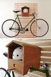 a cute house-shaped shelf can be used to store a bike and a helmet and maybe some more stuff is a very cool idea
