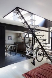 a creative idea – a vertical holder attached to a staircase – will make storage non-typical and will integrate your bike into decor