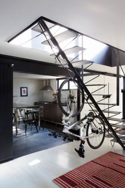 a creative idea - a vertical holder attached to a staircase - will make storage non-typical and will integrate your bike into decor