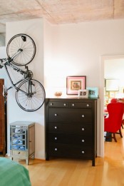 a special holder for the bike attached to the wall in the bedroom to show off your passion and make your interior bolder