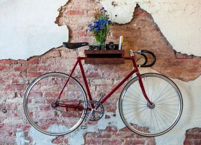 a floating shelf attached to a wall can easily hold your bike if it's not too heavy or if it's attached to the wall very well