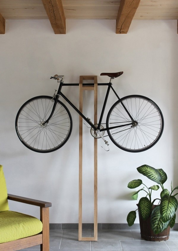 a simple and chic plywood holder for the bike is a very cool idea for a modern space, and it can be placed anywhere, from an entryway to a living room