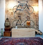 metal holders on the wall and a plywood unit for storing bikes are amazing and they match the industrial space