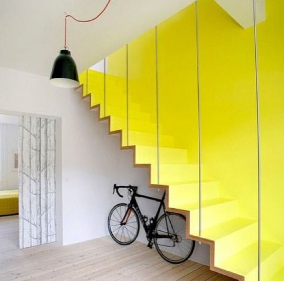 place your bike under the stairs to easily store it and make it part of your decor
