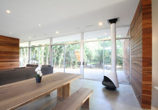 a modern meets contemporary sleek living room with a glass wall and a white Malm fireplace that brings warmth and coziness to the space