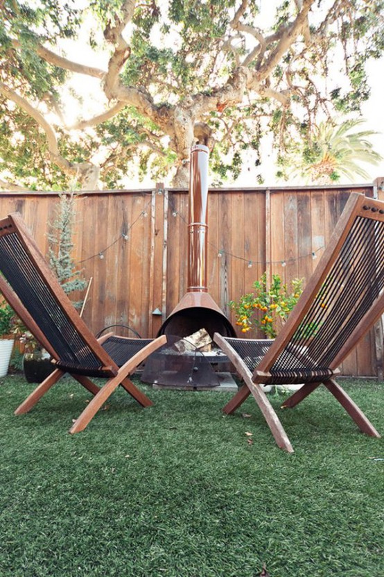 a small outdoor sitting space with a brown Malm fireplace and matching stained wooden chairs - you won't need anything else to enjoy fresh air and fire