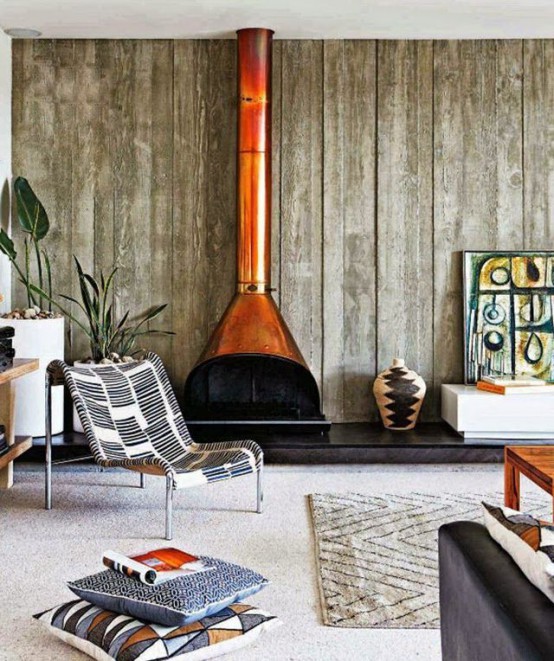 a beautiful living room with an accent wall clad with reclaimed wood, a rust-colored Malm fireplace, a boho chair and some elegant seating furniture