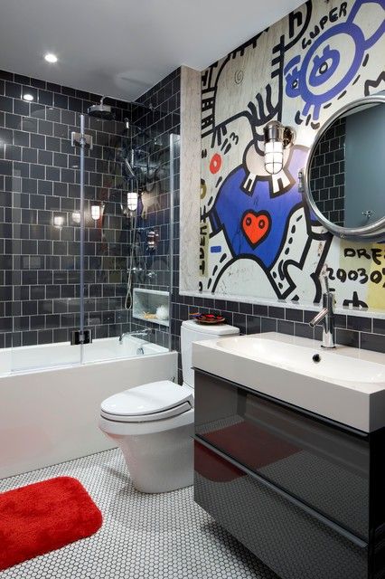 a modern black and white bathroom clad with penny and square tiles in black and white, a bold graffiti on the wall to add color and interest to the space