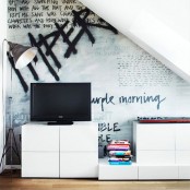 a Scandinavian living room with laconic white furniture, a TV, a floor lamp and a bold graffiti on the wall is wow