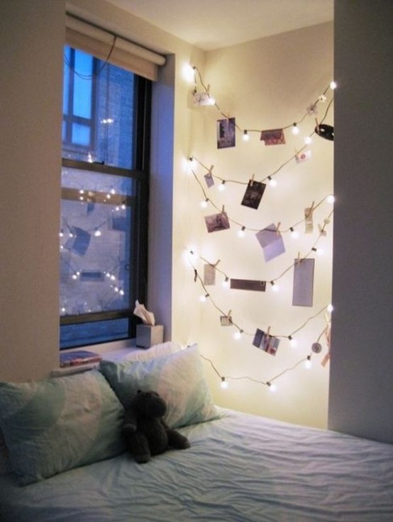 a neutral kid or teen room with string lights hanging in an awkward nook and holding photos, creating a lovely gallery wall