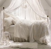 a dreamy white bedroom with a large canopy accented with lights over it is a fantastic idea if you enjoy light and don’t know how to add it in a creative way
