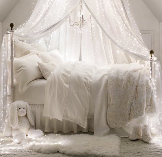 a dreamy white bedroom with a large canopy accented with lights over it is a fantastic idea if you enjoy light and don't know how to add it in a creative way