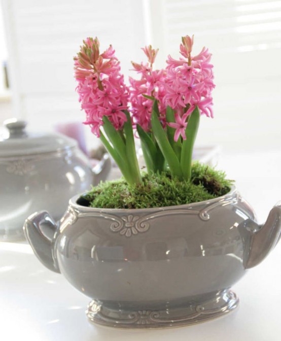 a grey sugar pot with pink hyacinths and moss is a cool vintage-inspired centerpiece or decoration for spring