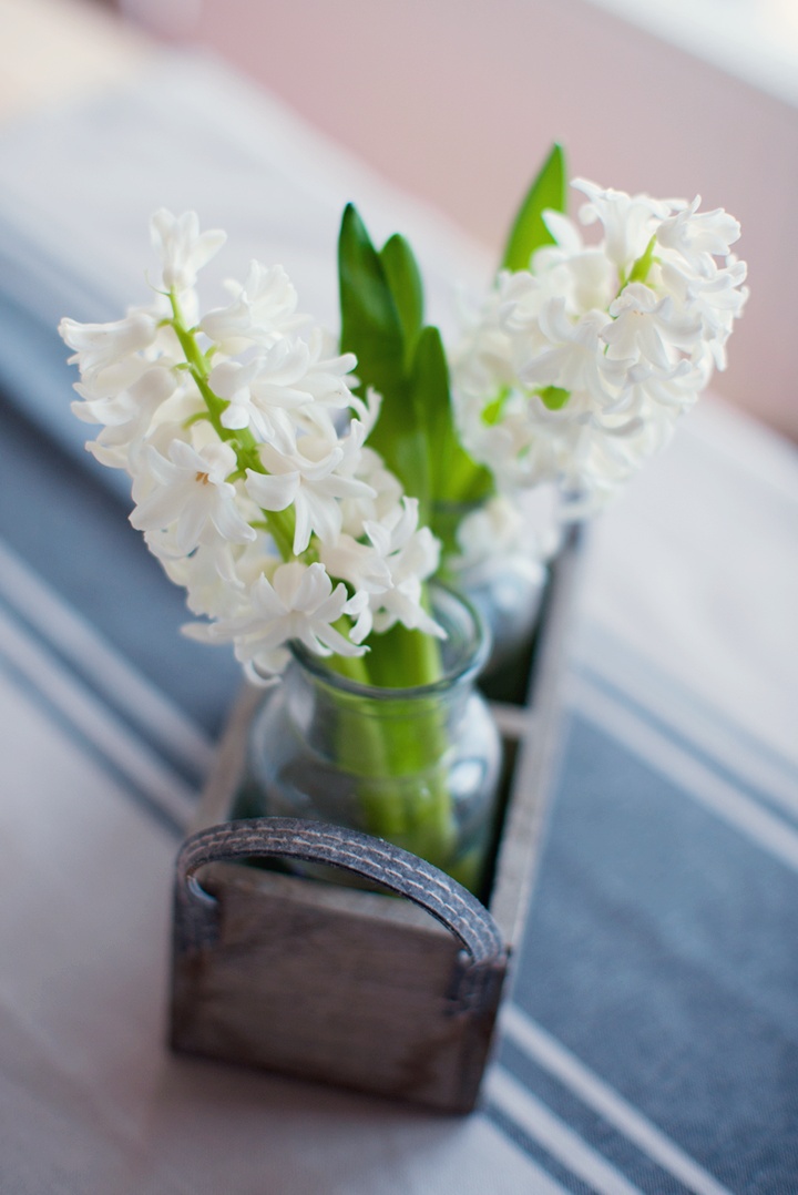 a wooden box with glass vases and white hyacinths for a rustic or farmhouse spring space