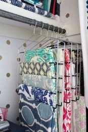 a holder with clothes hangers for fabric is a great idea for those who love sewing