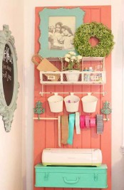 a wire storage unit and plastic buckets hanging on it is a cute idea with a vintage feel