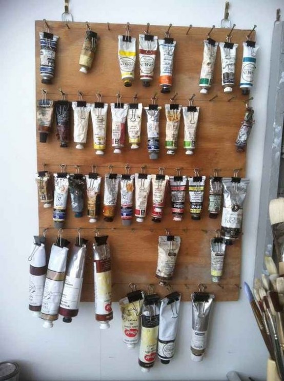 a wooden board with clips is great to store paints in tubes and saves a lot of space in your drawers