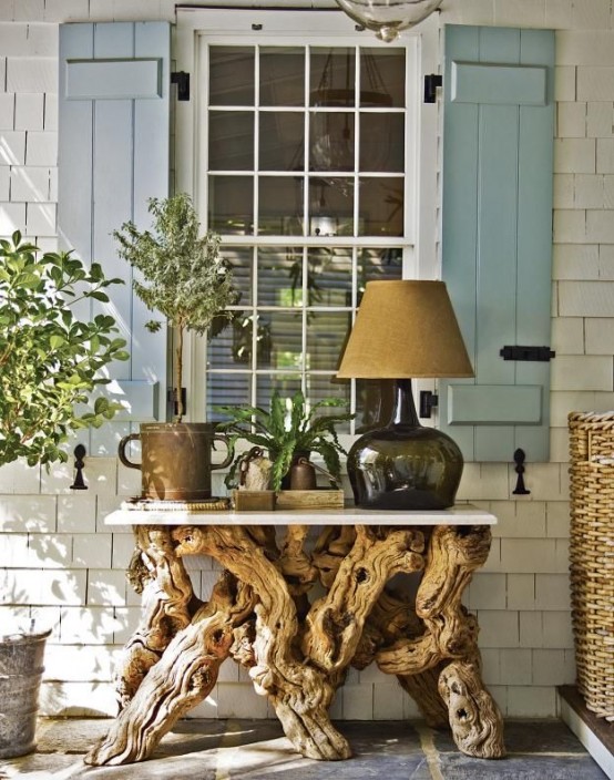 a stylish console table with a white tabletop and a driftwood base for a beachy feel