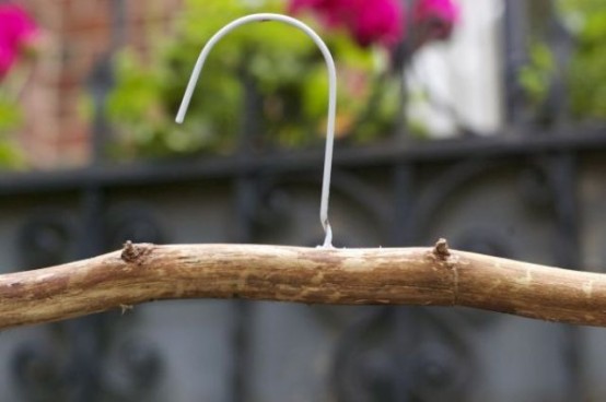 a driftwood clothes hanger is a cool idea for a beachy home