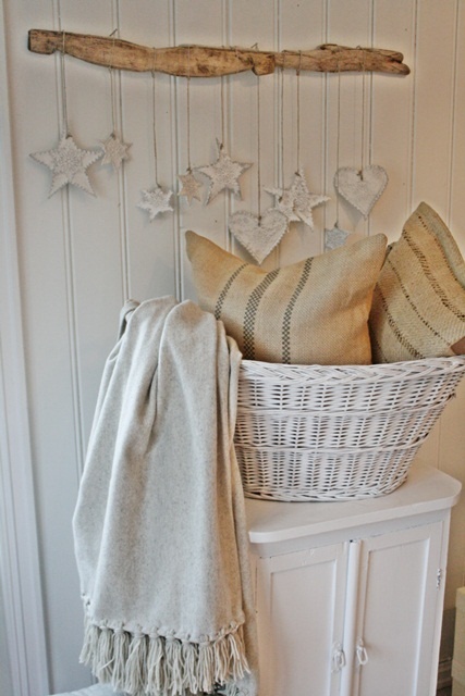 a rack with hanging whitewashed hearts for a relaxed and shabby chic feel