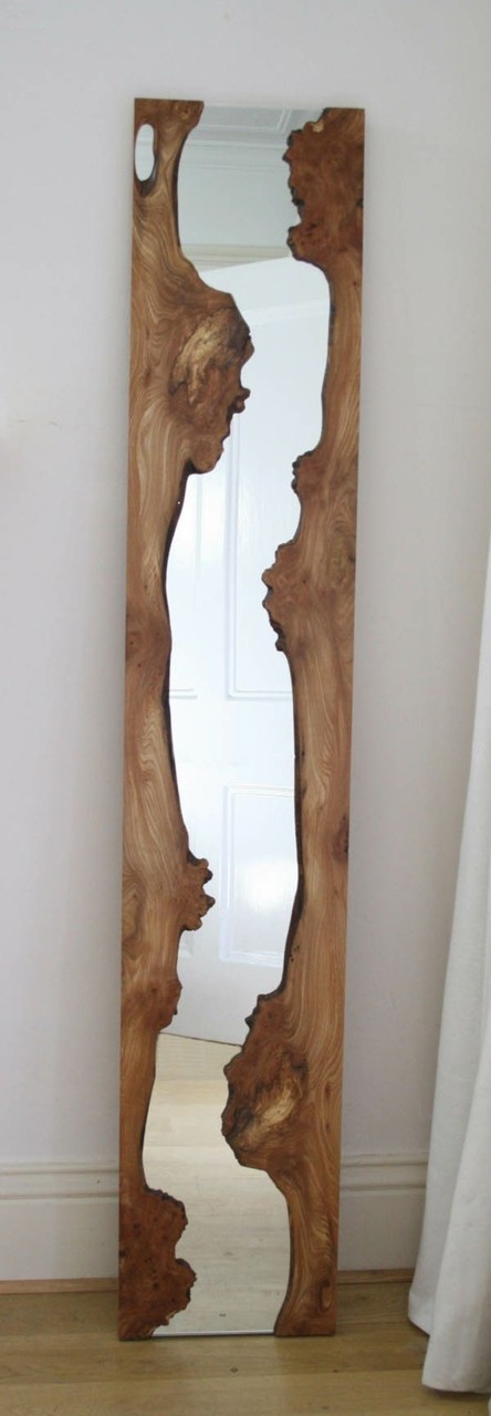 a unique narrow mirror in a driftwood frame looks very natural