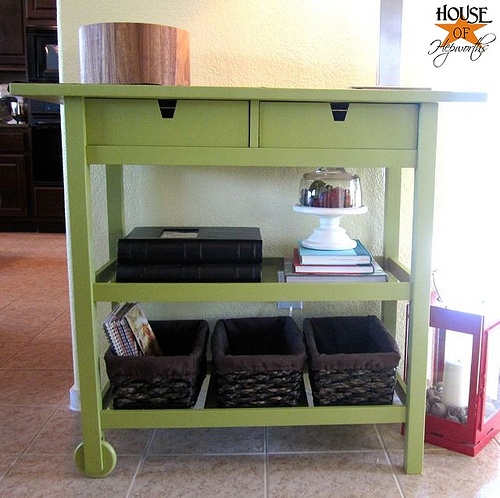 a green Forhoja cart with some baskets for storage is used for storign various stuff in a small and narrow space