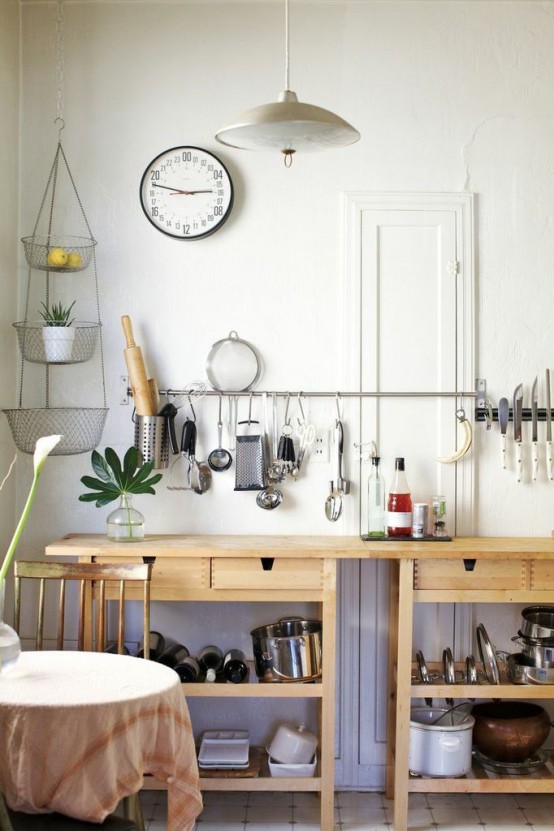a kitchen cooking space formed by two Ikea Forhoja carts and a large and long rail for hanging various stuff