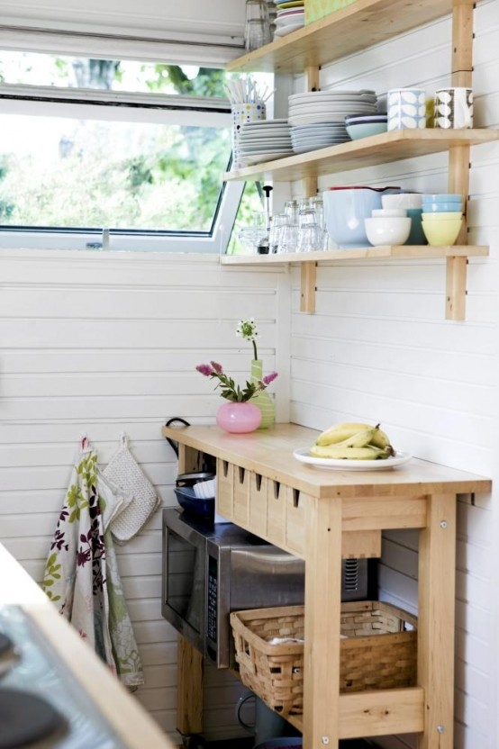 an Ikea Forhoja cart with small drawers for storage, with open storage and matching open shelves over the cart