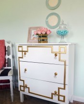a vintage-inspired Tarva dresser with gold inlays and gold and crystal pulls for a touch of art deco