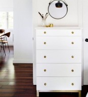 a white Tarva with brass knobs is a stylish and timeless storage piece, and the color combo is perfect
