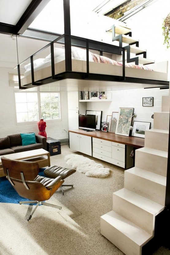 a mid-century modern to Scandinavian space done in neutrals, black and with stained wood, a small loft bedroom and a ladder up