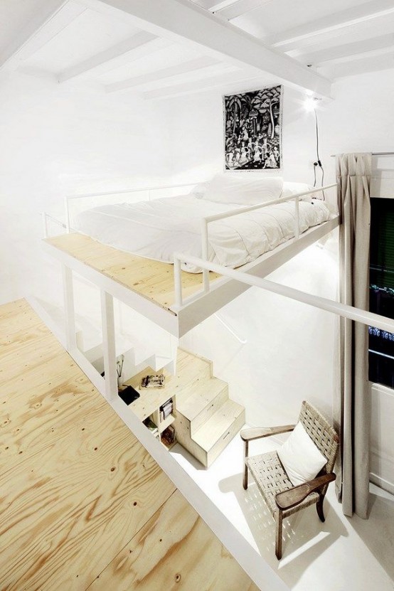 a creative floating loft bedroom that shows off just a bed with neutral bedding and some lights around