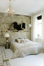 chic and glam furniture and accessories are calmed down with a white brick wall and platform that add a raw feel
