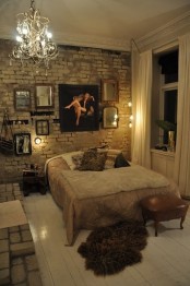 an eclectic bedroom with a white brick wall that adds a raw touch to the space and elegant artworks