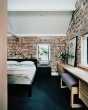 stylish contemporary bedroom is spruced up with exposed brick walls that give it a character and a unique look