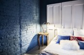 paint your brick wall with any color you like and that matches your home decor, here teal paint gives a unique look to the bedroom