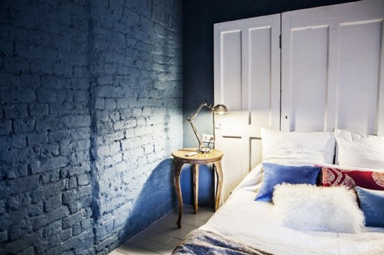 paint your brick wall with any color you like and that matches your home decor, here teal paint gives a unique look to the bedroom