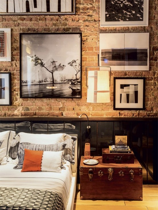 a vintage industrial bedroom with a brick wall and sleek black panels, vintage furniture and a gallery wall