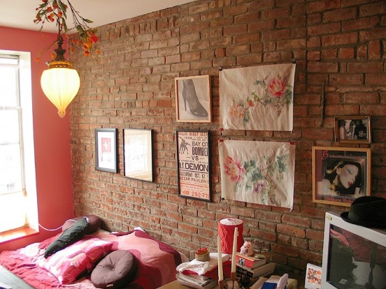 a brigth and fun bedroom with an exposed brick wall, a gallery wall and colorful touches here and there