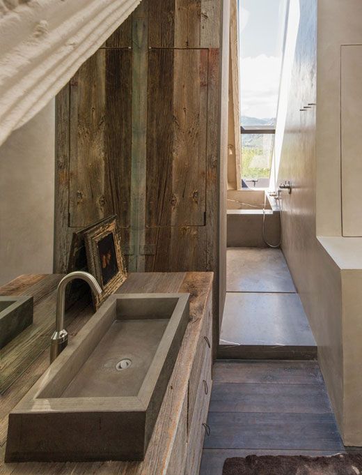 a chalet bathroom with white concrete, with reclaimed wood walls and a rectangular sink of stone is chic and modern