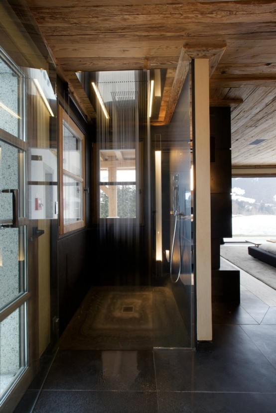 a contemporary chalet bathroom clad with tiles, with a skylight and a window for more natural light and a rain shower