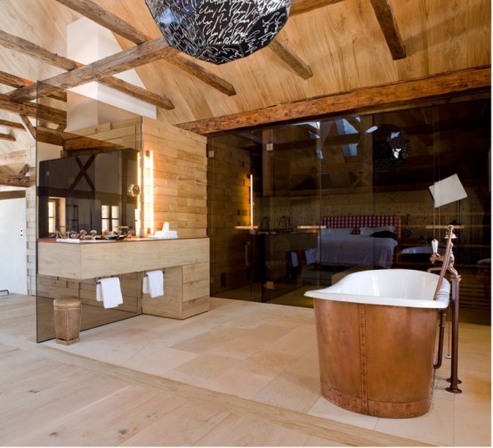 a contemporary chalet bathroom with light-stained wood wall and a ceiling, a steam room with black glass, a tub clad with copper is amazing