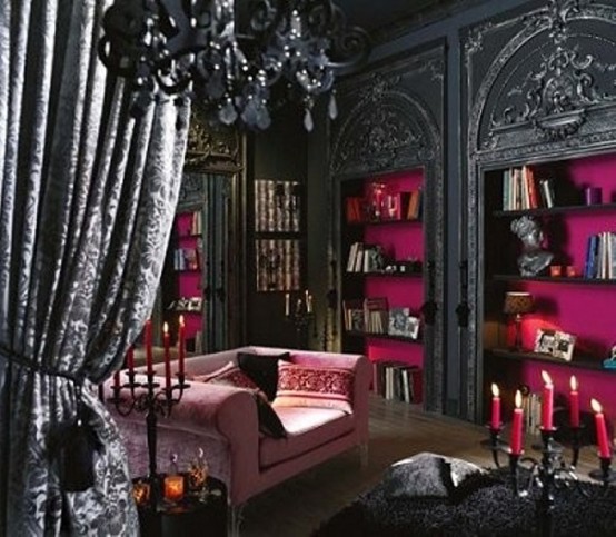 a glam black and pink Gothic bedroom with black walls, built-in shelves with fuchsia backing, refiend furniture and a crystal chandelier just wows