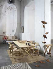 an eclectic space with whitewashed brick walls, double-height ceilings, modern wooden and leather furniture and butterflies for decor