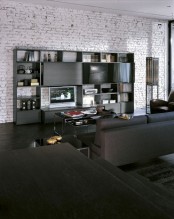 a contemporary living room with whitewashed brick walls, dark and black furniture and lamps is a stylish and catchy space
