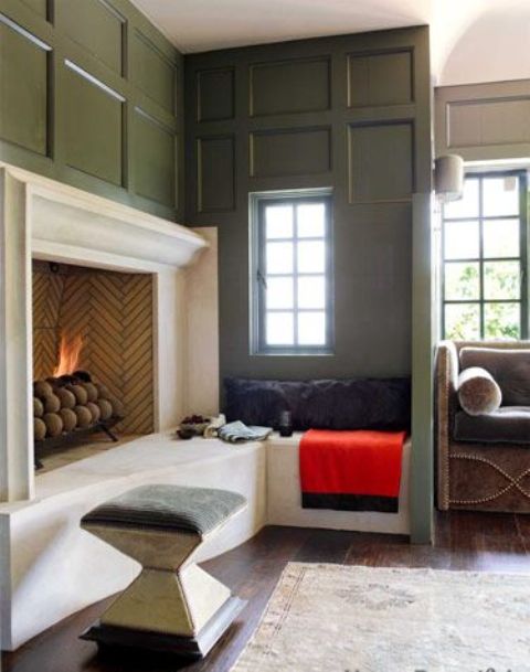 a stylish fireplace nook with an open fireplace, a small ccozy nook by the window with a pillow and a stool is welcoming and cozy